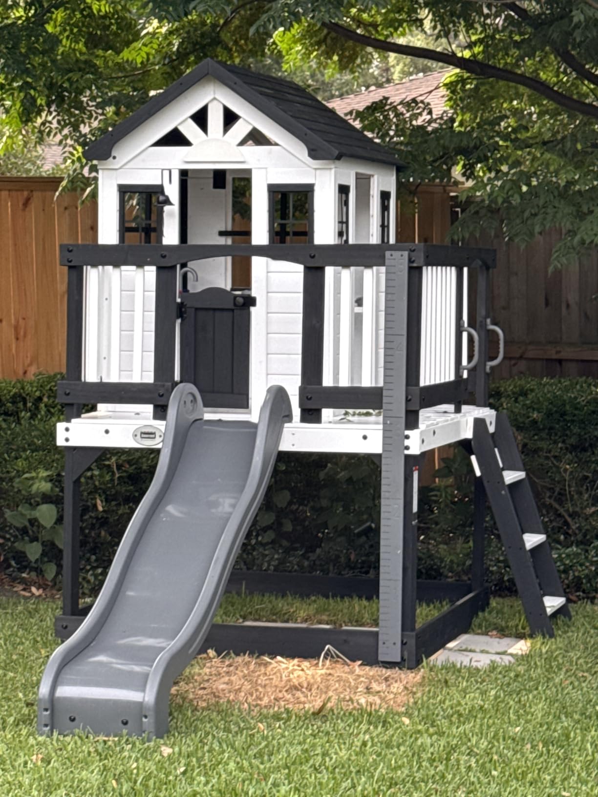 Backyard Discovery Beacon Heights Elevated Cedar Wooden Kids Playhouse with Wave Slide, Play Kitchen, Wrap-Around Deck, Flat-Step Ladder, Half Door, Windows, Bell, and Growth Chart for Outdoor Play customer photo 1