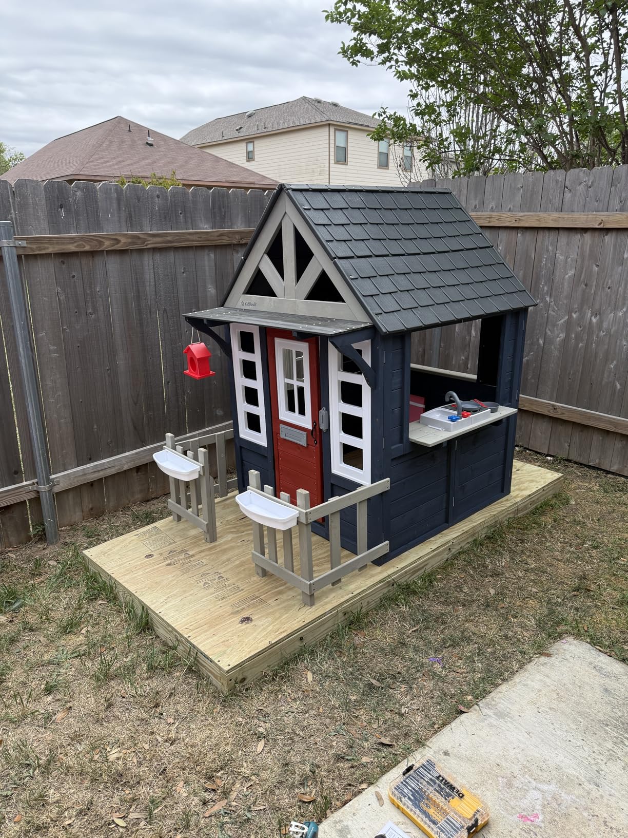 KidKraft Riverscape Wooden Playhouse with Working Doorbell, Fence, Kitchen, Pet Door, Chalkboards and Planters customer photo 1